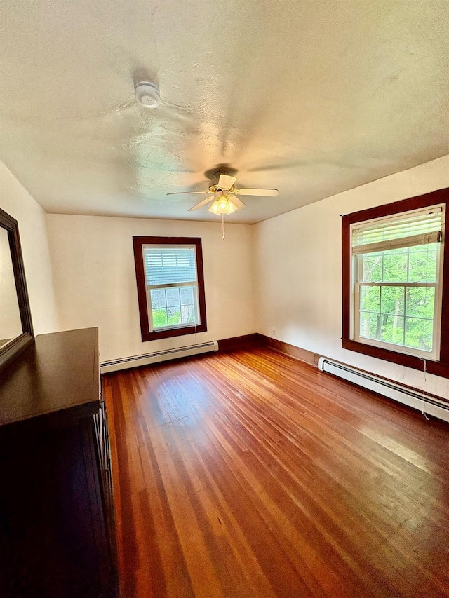 13 Rockland Rd, Roscoe, NY 12776 - spare room featuring a baseboard heating unit, ceiling fan, wood finished floors, a smoke detector, and a textured ceiling