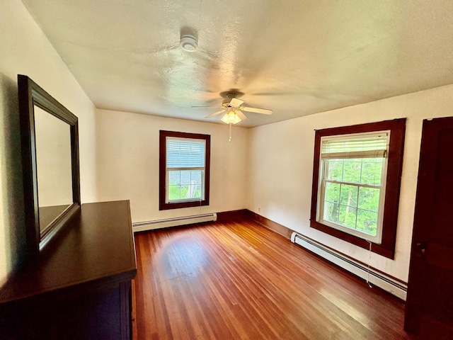 13 Rockland Rd, Roscoe, NY 12776 - empty room with baseboard heating, dark wood-type flooring, and a ceiling fan