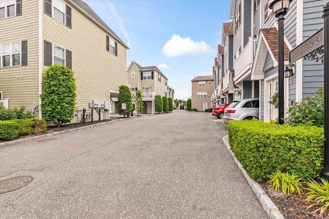 24 Hearthstone Ct Unit 24, Farmingdale, NY 11735 - view of asphalt road featuring a residential view, curbs, and street lights