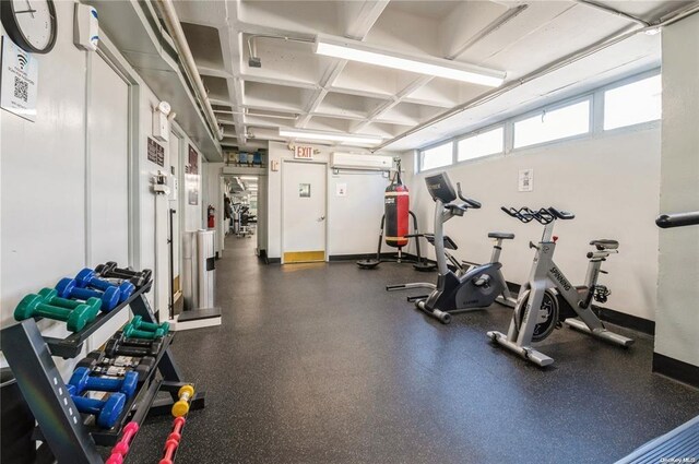 152-18 Union Tpke Unit 9P, Flushing, NY 11367 - workout area with an AC wall unit, baseboards, and coffered ceiling