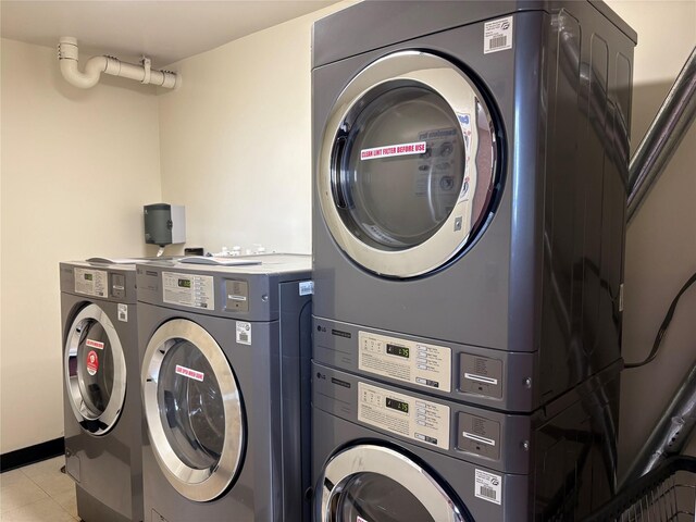 152-18 Union Tpke Unit 9P, Flushing, NY 11367 - laundry room with stacked washer and clothes dryer and light tile patterned flooring