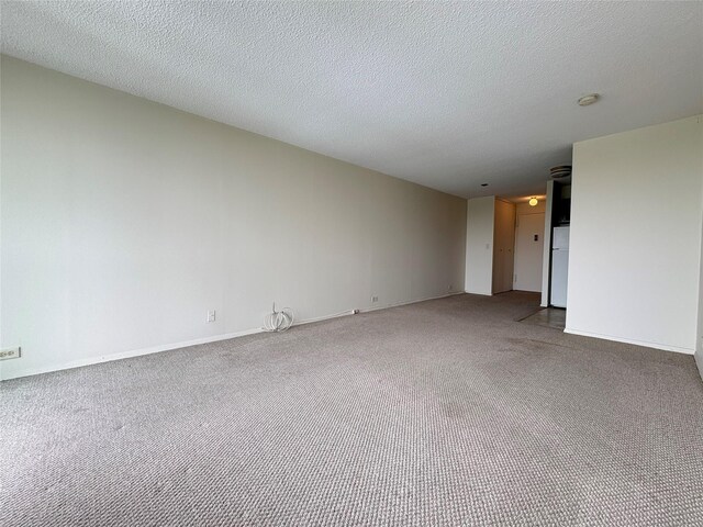 152-18 Union Tpke Unit 9P, Flushing, NY 11367 - spare room featuring carpet floors, baseboards, a smoke detector, and a textured ceiling