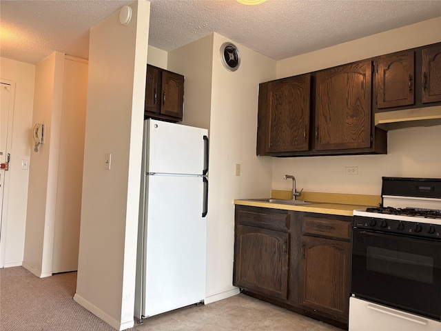 152-18 Union Tpke Unit 9P, Flushing, NY 11367 - kitchen featuring freestanding refrigerator, black gas range, dark brown cabinets, a sink, and light countertops