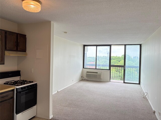152-18 Union Tpke Unit 9P, Flushing, NY 11367 - kitchen with range with gas stovetop, a textured ceiling, light carpet, dark brown cabinets, and light countertops