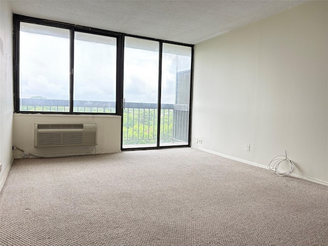 152-18 Union Tpke Unit 9P, Flushing, NY 11367 - carpeted spare room featuring an AC wall unit, a textured ceiling, and baseboards