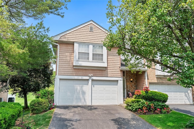 81 Hidden Ridge Dr, Syosset, NY 11791 - view of front facade with an attached garage and driveway