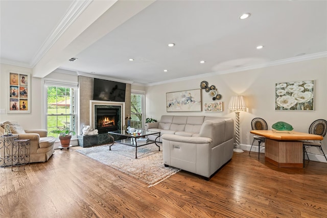 81 Hidden Ridge Dr, Syosset, NY 11791 - living room with wood finished floors, ornamental molding, recessed lighting, and a warm lit fireplace