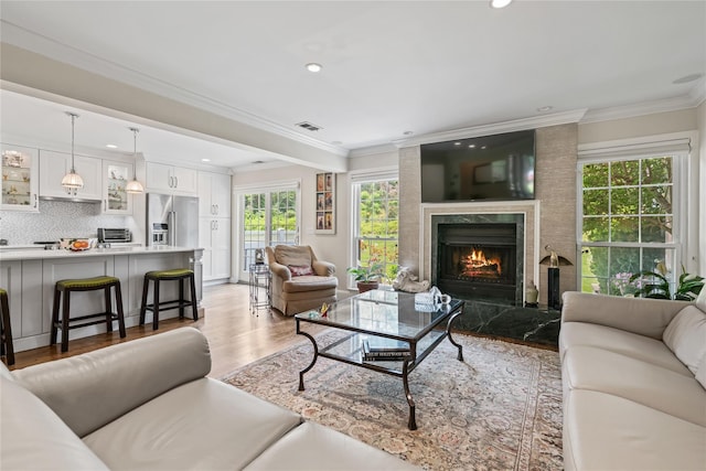 81 Hidden Ridge Dr, Syosset, NY 11791 - living area with recessed lighting, a premium fireplace, crown molding, and light wood-style flooring