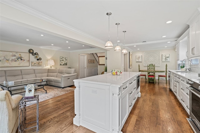 81 Hidden Ridge Dr, Syosset, NY 11791 - kitchen featuring white cabinets, recessed lighting, light countertops, dark wood finished floors, and a kitchen island