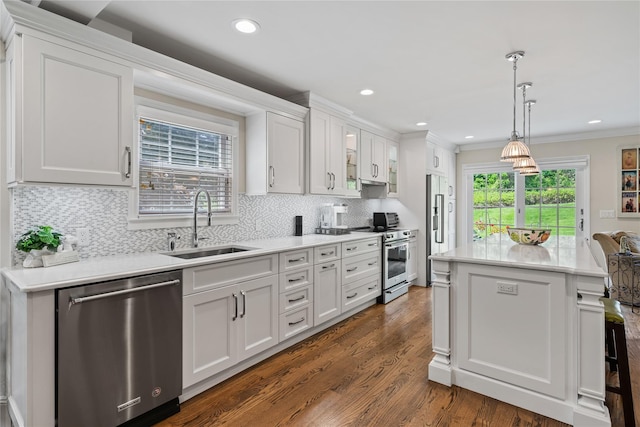 81 Hidden Ridge Dr, Syosset, NY 11791 - kitchen with stainless steel appliances, backsplash, white cabinets, light countertops, and a kitchen island