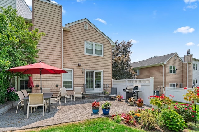 81 Hidden Ridge Dr, Syosset, NY 11791 - back of house featuring a patio and a chimney