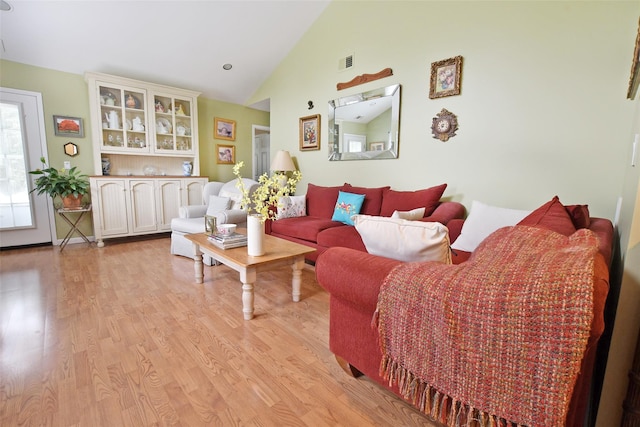 9 Quail Path, Coram, NY 11727 - living area featuring light wood finished floors and high vaulted ceiling
