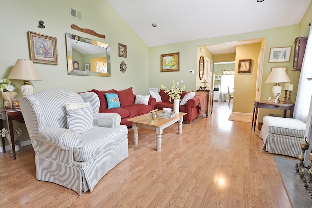 9 Quail Path, Coram, NY 11727 - living room featuring light wood-style flooring, high vaulted ceiling, and baseboards