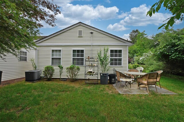 9 Quail Path, Coram, NY 11727 - back of house featuring central air condition unit, a patio, and a lawn