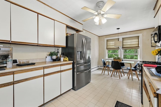 305 Columbus Ave, Harrison, NY 10604 - kitchen with black microwave, stainless steel refrigerator with ice dispenser, white cabinetry, and light countertops