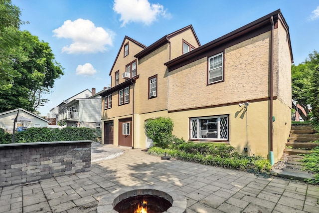 305 Columbus Ave, Harrison, NY 10604 - view of patio / terrace with an outdoor fire pit, stairway, and a residential view