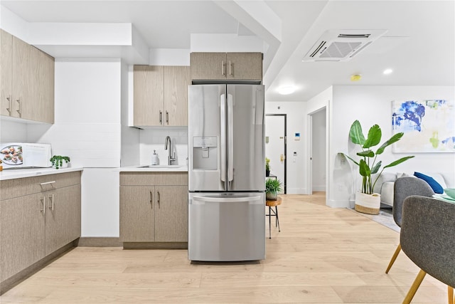 131-19 Fowler Ave Unit 6C, Flushing, NY 11355 - kitchen featuring stainless steel refrigerator with ice dispenser, a sink, light wood-style floors, and light countertops