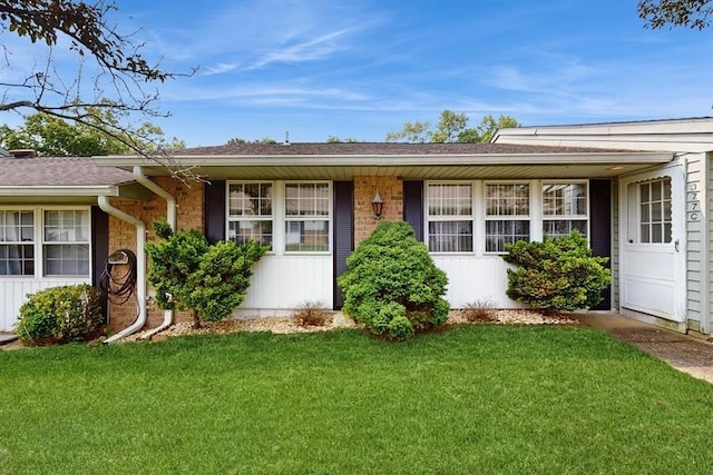 377C Woodbridge Dr, Ridge, NY 11961 - ranch-style house with a front yard and brick siding