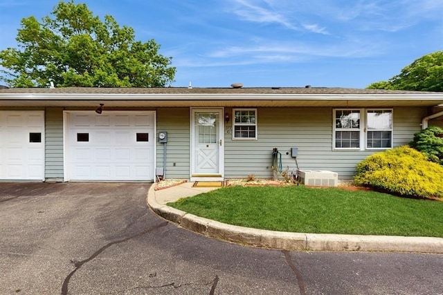 377C Woodbridge Dr, Ridge, NY 11961 - view of front facade featuring asphalt driveway, a front yard, and a garage