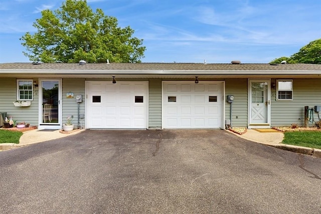 377C Woodbridge Dr, Ridge, NY 11961 - ranch-style house featuring asphalt driveway, a garage, and a shingled roof
