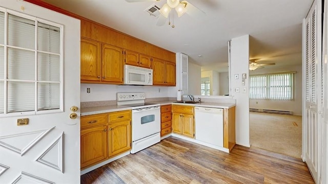 377C Woodbridge Dr, Ridge, NY 11961 - kitchen with white appliances, ceiling fan, light countertops, a baseboard heating unit, and light wood-type flooring