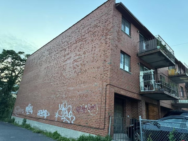 40-18 165th St, Flushing, NY 11358 - view of side of property featuring brick siding and a balcony