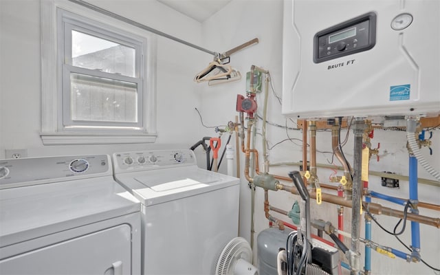 28 Walnut Rd, Inwood, NY 11096 - washroom featuring tankless water heater and washer and dryer