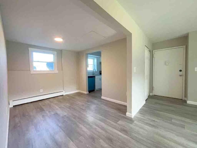 1548 Rte 9 Unit 1A, Wappingers Falls, NY 12590 - unfurnished room featuring a baseboard radiator, wood finished floors, a sink, and baseboards