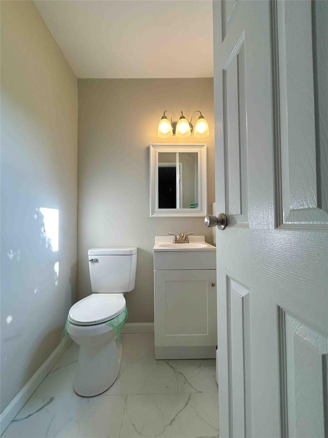 1548 Rte 9 Unit 1A, Wappingers Falls, NY 12590 - bathroom with vanity, marble look tile flooring, toilet, and baseboards