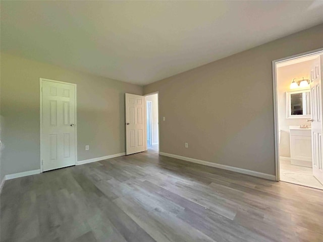 1548 Rte 9 Unit 1A, Wappingers Falls, NY 12590 - unfurnished bedroom featuring wood finished floors, baseboards, and ensuite bathroom