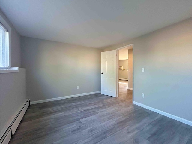1548 Rte 9 Unit 1A, Wappingers Falls, NY 12590 - unfurnished room featuring a baseboard heating unit, baseboards, and dark wood-type flooring