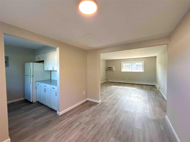 1548 Rte 9 Unit 1A, Wappingers Falls, NY 12590 - unfurnished living room with a baseboard radiator, wood finished floors, and baseboards