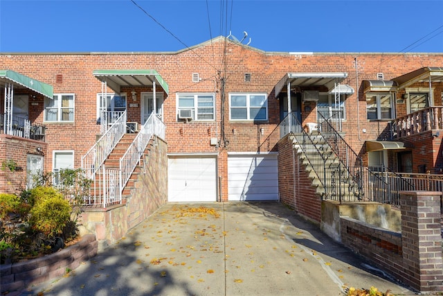 1319 E 86th St, Brooklyn, NY 11236 - view of property featuring driveway, an attached garage, and stairs