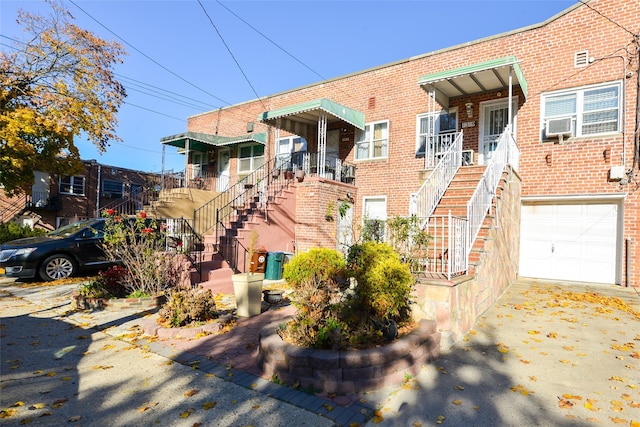 1319 E 86th St, Brooklyn, NY 11236 - multi unit property with brick siding, stairs, an attached garage, concrete driveway, and cooling unit