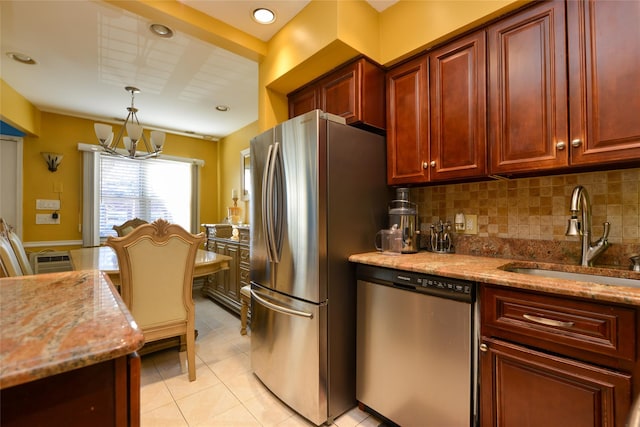 1319 E 86th St, Brooklyn, NY 11236 - kitchen with stainless steel appliances, a chandelier, light stone countertops, dark brown cabinets, and pendant lighting