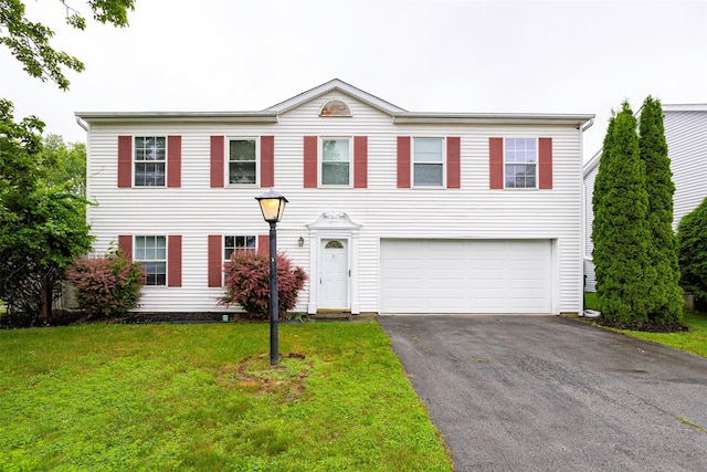 15 Pond St, Poughkeepsie, NY 12603 - colonial home featuring an attached garage, asphalt driveway, and a front lawn