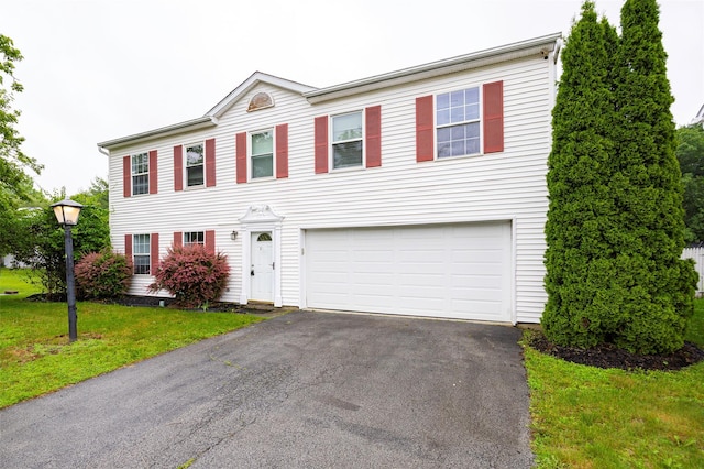 15 Pond St, Poughkeepsie, NY 12603 - colonial home featuring an attached garage, asphalt driveway, and a front lawn
