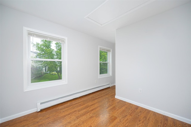15 Pond St, Poughkeepsie, NY 12603 - unfurnished room with baseboard heating, healthy amount of natural light, wood finished floors, and baseboards