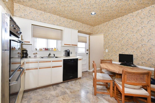 8519 212th St, Hollis Hills, NY 11427 - kitchen with black appliances, light countertops, wallpapered walls, white cabinets, and recessed lighting