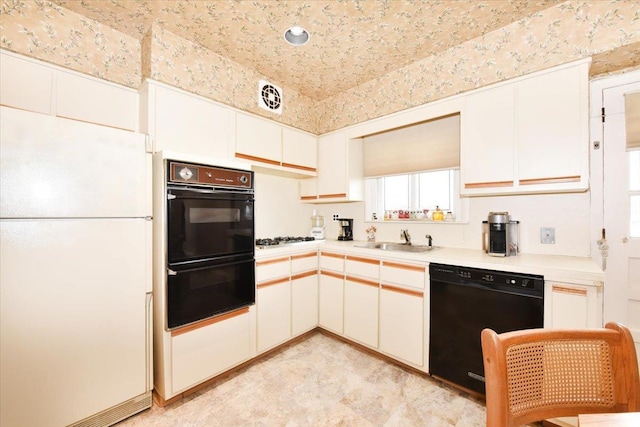 8519 212th St, Hollis Hills, NY 11427 - kitchen featuring black appliances, light countertops, and white cabinets