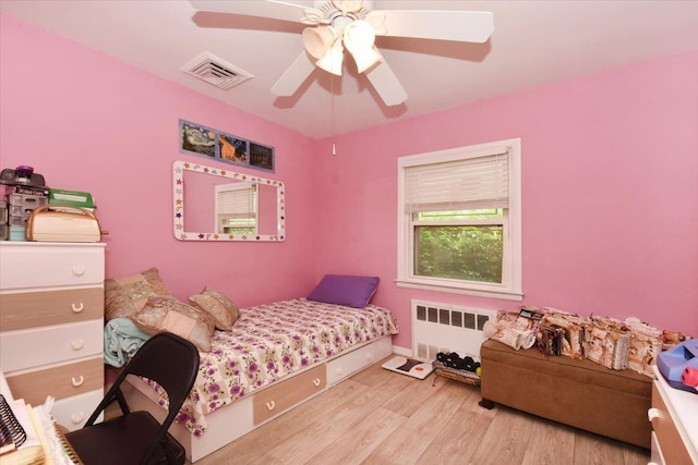 8519 212th St, Hollis Hills, NY 11427 - bedroom with radiator, wood finished floors, and a ceiling fan