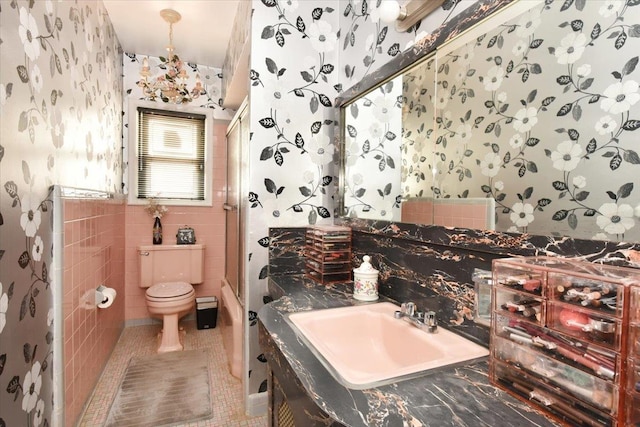 8519 212th St, Hollis Hills, NY 11427 - full bath featuring wallpapered walls, a shower, vanity, tile walls, and tile patterned flooring