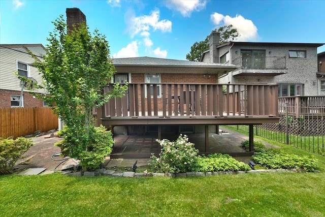 8519 212th St, Hollis Hills, NY 11427 - back of property with a chimney, a wooden deck, and brick siding