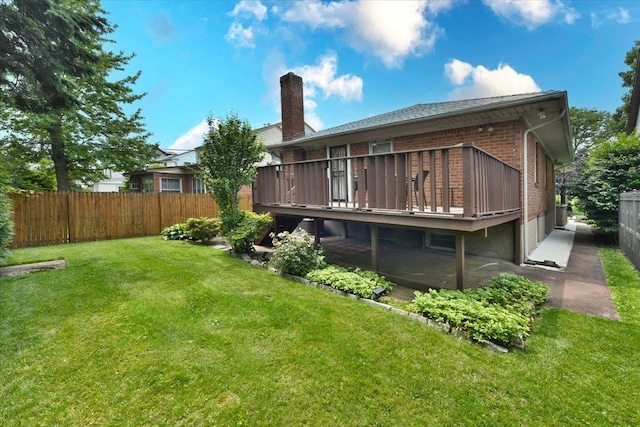 8519 212th St, Hollis Hills, NY 11427 - back of house featuring a chimney, a deck, and brick siding