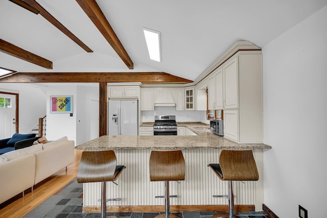 39 Cliff Rd, Greenwood Lake, NY 10925 - kitchen with white refrigerator with ice dispenser, stainless steel gas range oven, glass insert cabinets, a peninsula, and white cabinetry