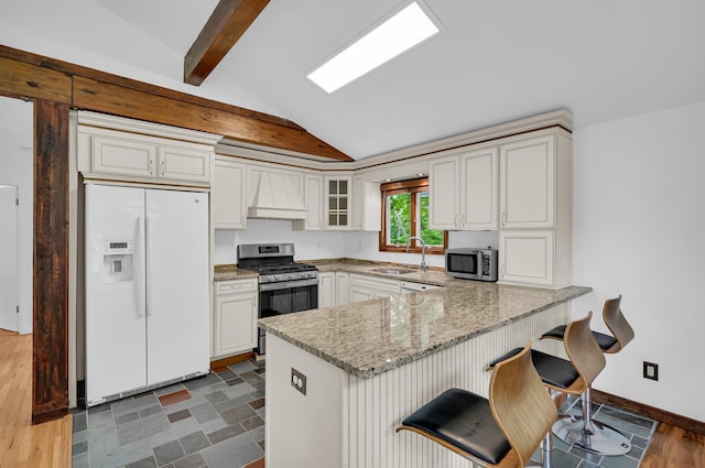 39 Cliff Rd, Greenwood Lake, NY 10925 - kitchen featuring stainless steel appliances, a peninsula, premium range hood, light stone countertops, and glass insert cabinets