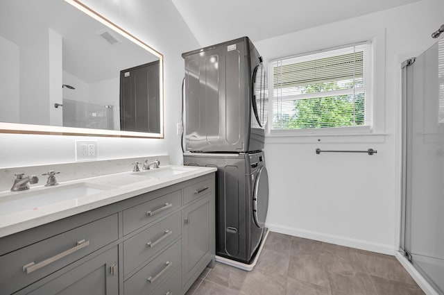 39 Cliff Rd, Greenwood Lake, NY 10925 - bathroom featuring stacked washer / dryer, a shower stall, and double vanity