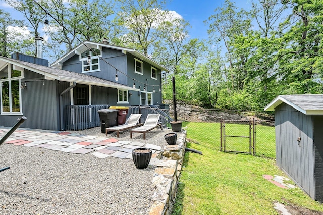 39 Cliff Rd, Greenwood Lake, NY 10925 - back of property featuring a gate, a patio, and a shingled roof