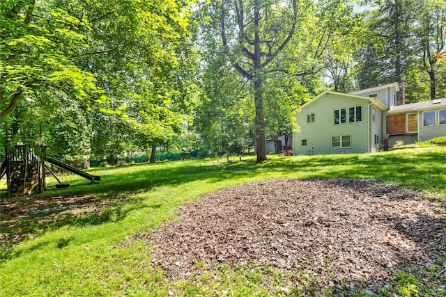19 Farview Ter, Airmont, NY 10901 - view of green lawn featuring a playground and view of scattered trees