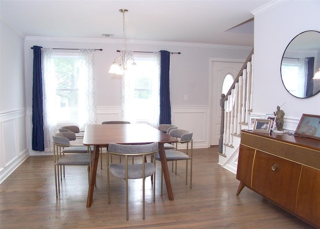 8 W Narcissus Rd, Mastic Beach, NY 11951 - dining room featuring stairs, a decorative wall, wood finished floors, wainscoting, and a chandelier